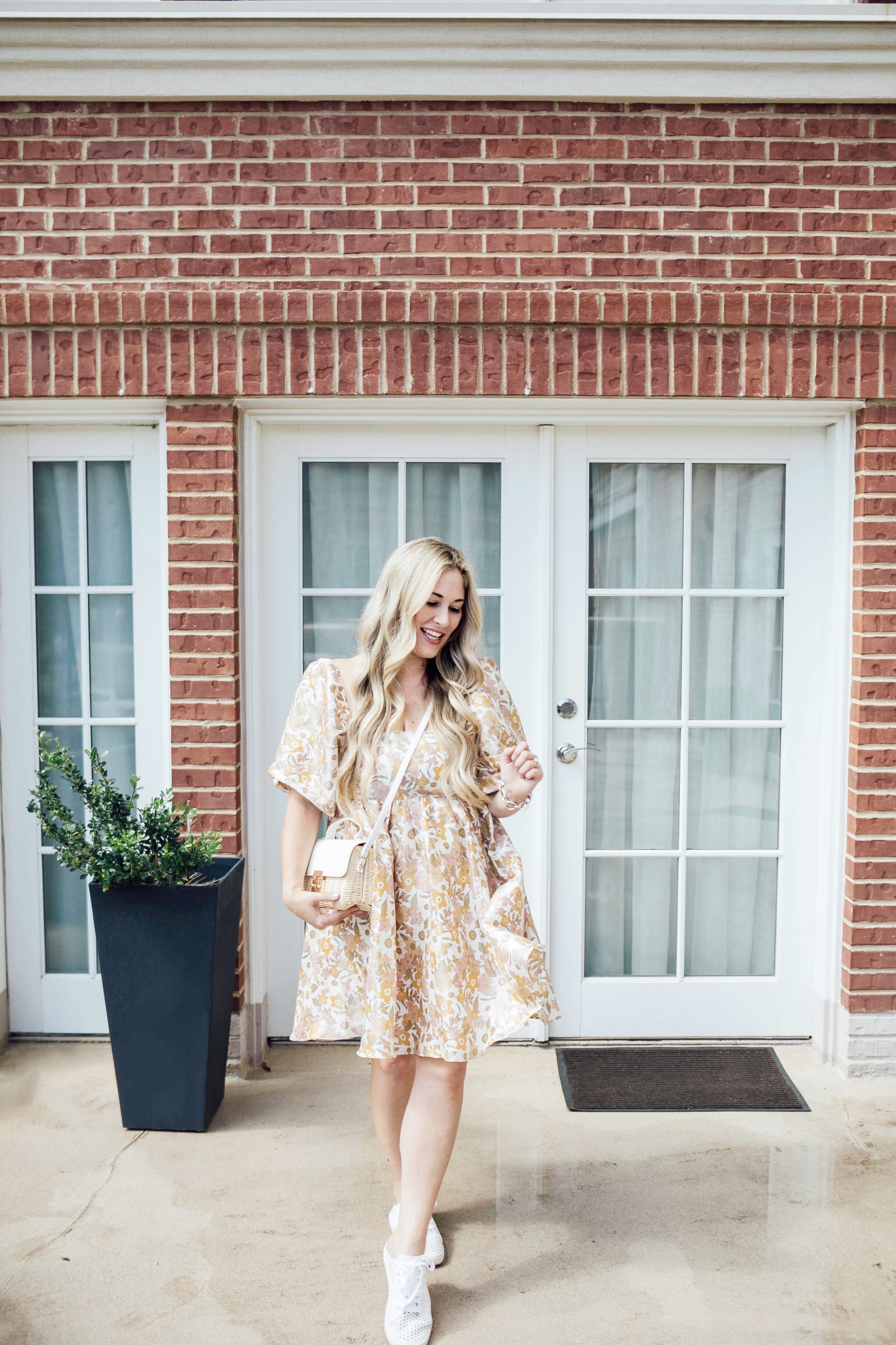 Cute White Sneakers for women styled by top US mom fashion blogger, Walking in Memphis in High Heels: image of a woman wearing Red Dress Mule White Sneakers