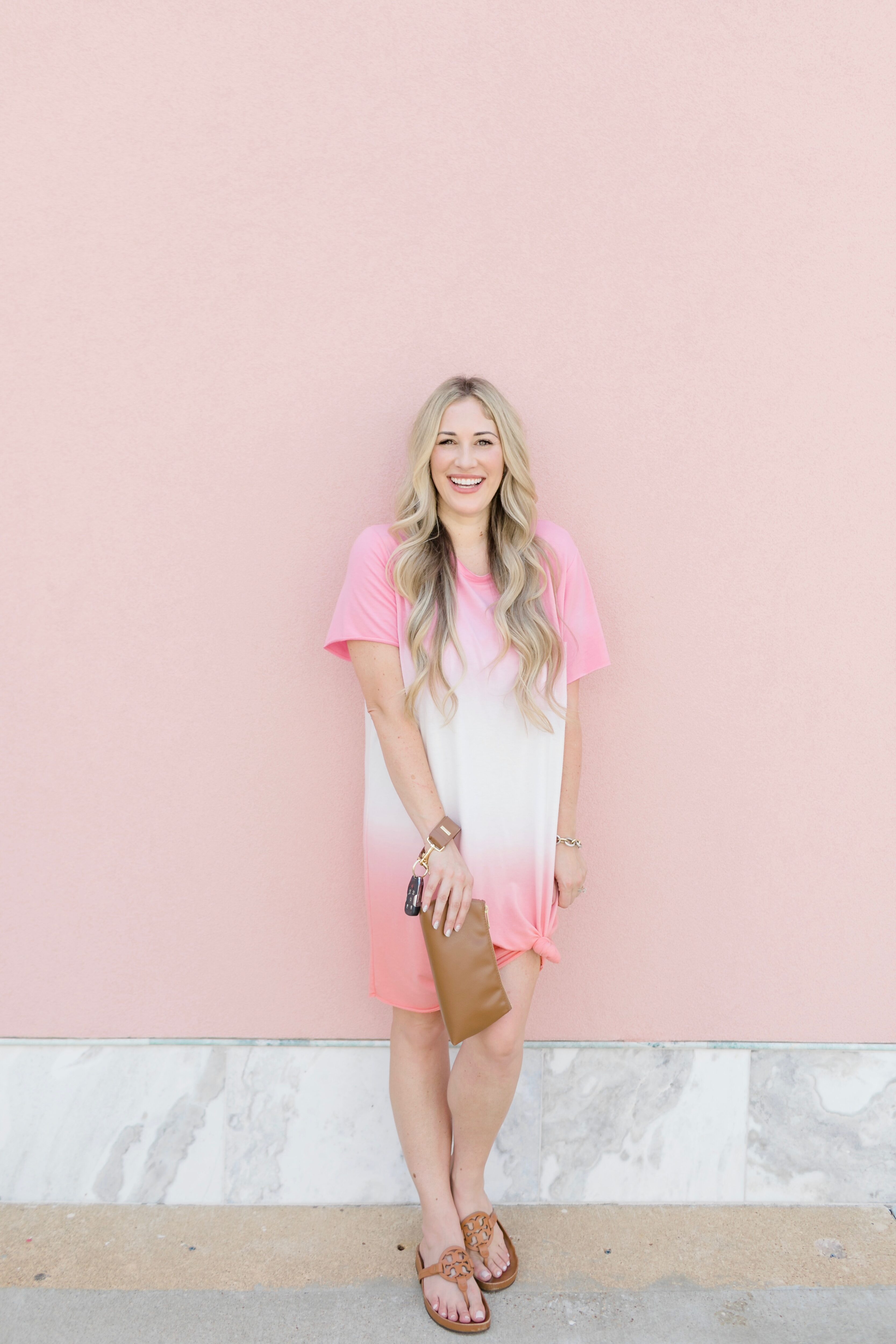 Late summer casual outfit featured by top US mommy fashion blogger, Walking in Memphis in High Heels: image of a woman wearing a Mud Pie pink tie dye dress, Tory Burch sandals and a Keyper wristlet.