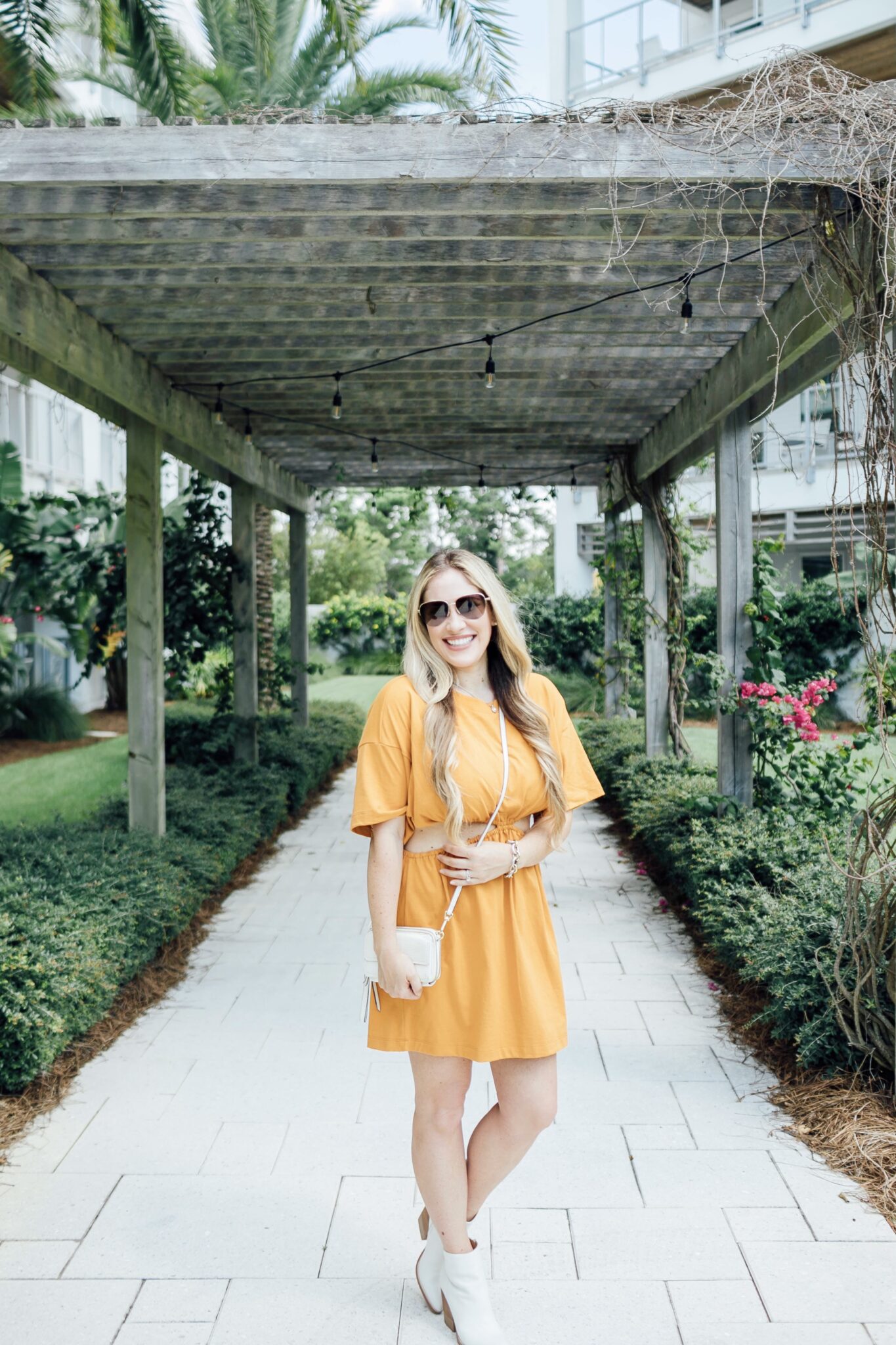 Summer to fall look featured by top US mom fashion blogger, Walking in Memphis in High Heels: image of a woman wearing a yellow Free People dress and Marc Fisher white booties.