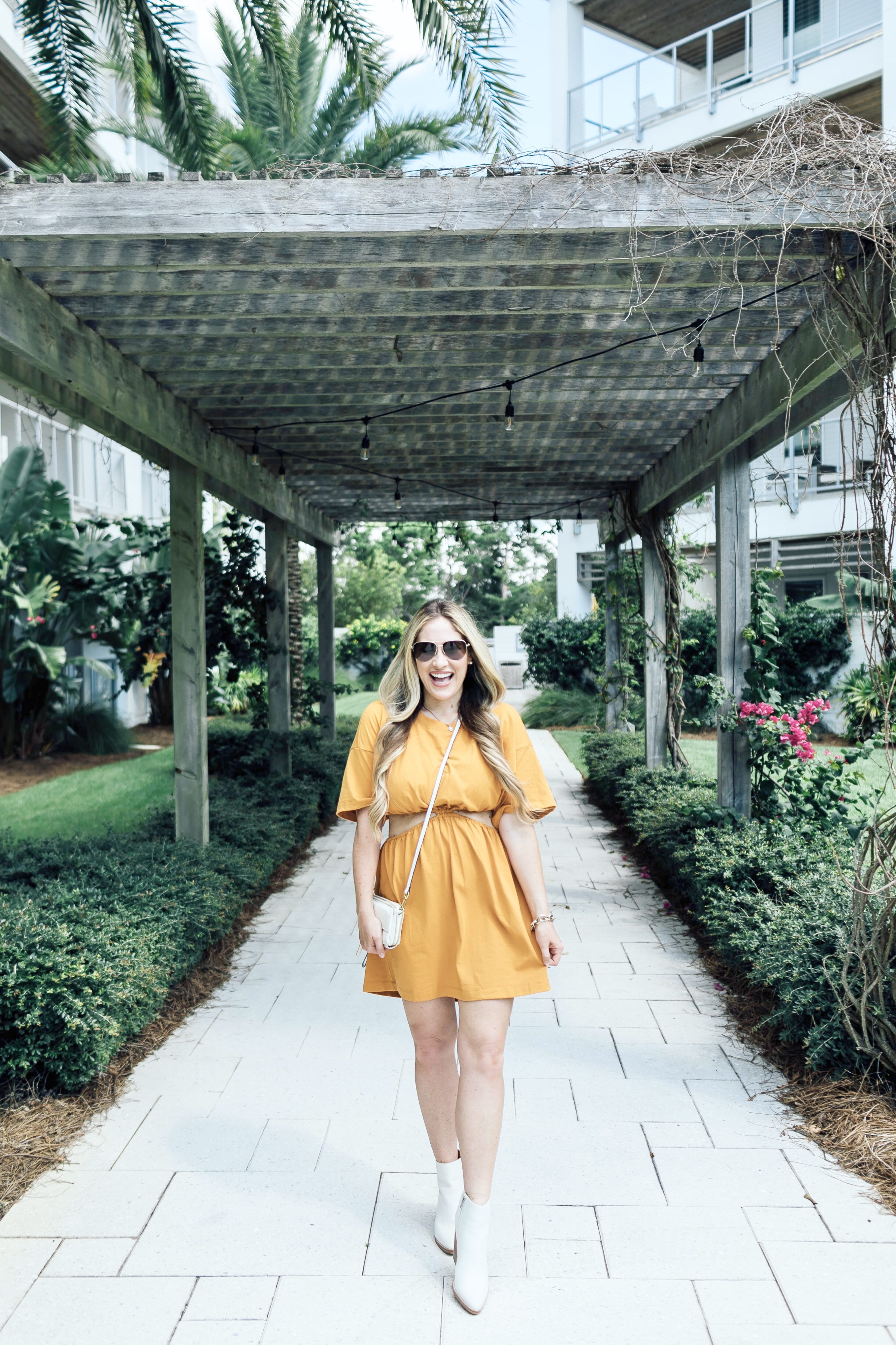 Summer to fall look featured by top US mom fashion blogger, Walking in Memphis in High Heels: image of a woman wearing a yellow Free People dress and Marc Fisher white booties.