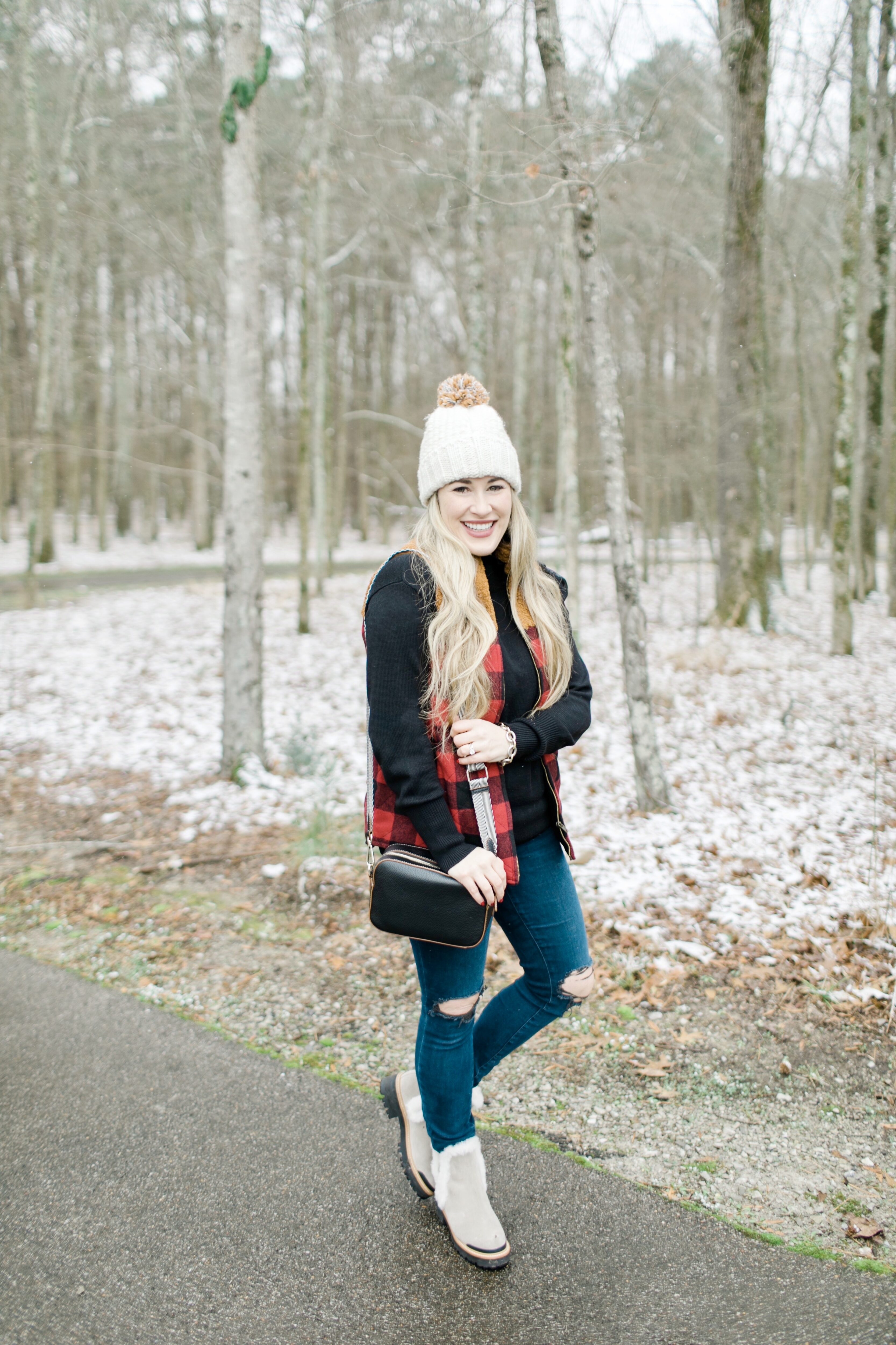 Best winter vests for women featured by top US mom fashion blogger, Walking in Memphis in High Heels: image of a woman wearing a Maurices buffalo plaid vest.
