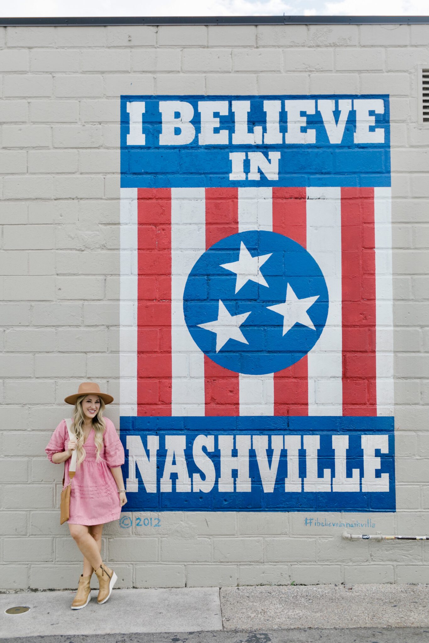 country music concert outfit: western hat, midi dress, cowboy boots